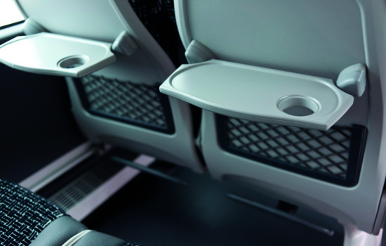 Eating tray with cup holder in luxury coach