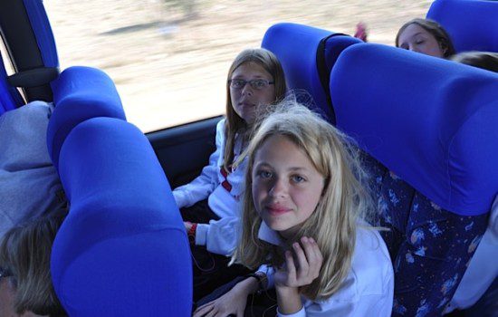 Students sitting in luxury coach reclining seat