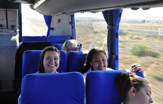 Studentssitting in reclining coach seats